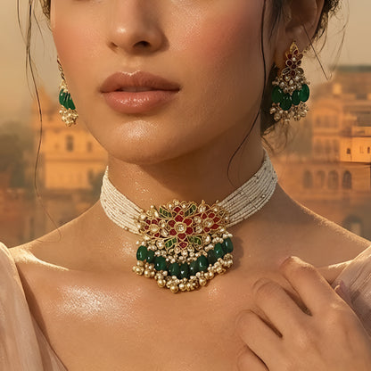 Traditional Kundan pearl choker necklace set with green bead drops and matching earrings in gold-plated finish for bridal and festive wear.