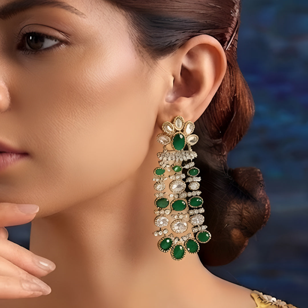 Luxury gold-plated chandelier earrings featuring emerald green oval stones and sparkling American diamonds for women.