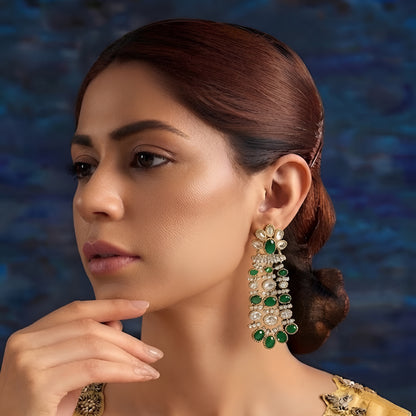 Luxury gold-plated chandelier earrings featuring emerald green oval stones and sparkling American diamonds for women.