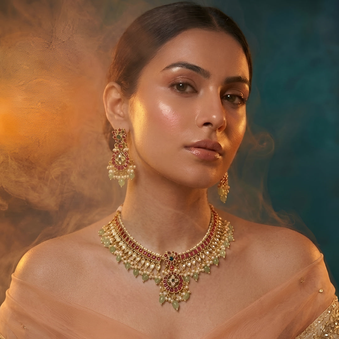 Traditional Kundan choker necklace set with ruby stones, green bead drops, gold finish, and matching earrings for bridal and wedding wear.