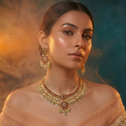 Traditional Kundan choker necklace set with ruby stones, green bead drops, gold finish, and matching earrings for bridal and wedding wear.