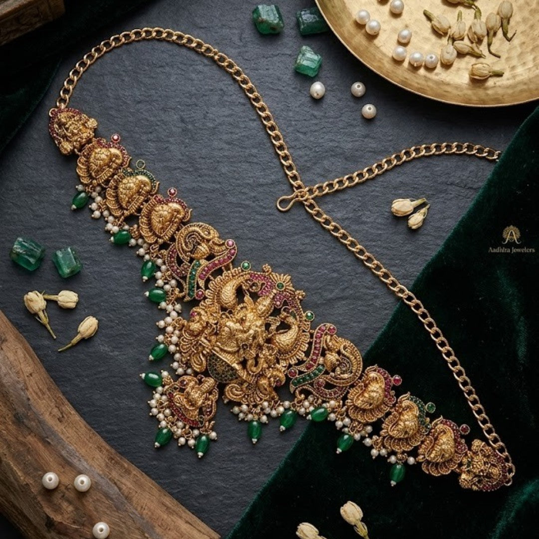 Traditional gold plated Lakshmi temple waist belt (Vaddanam) with green bead drops and pearl accents for bridal, wedding, festive, and classical dance wear.