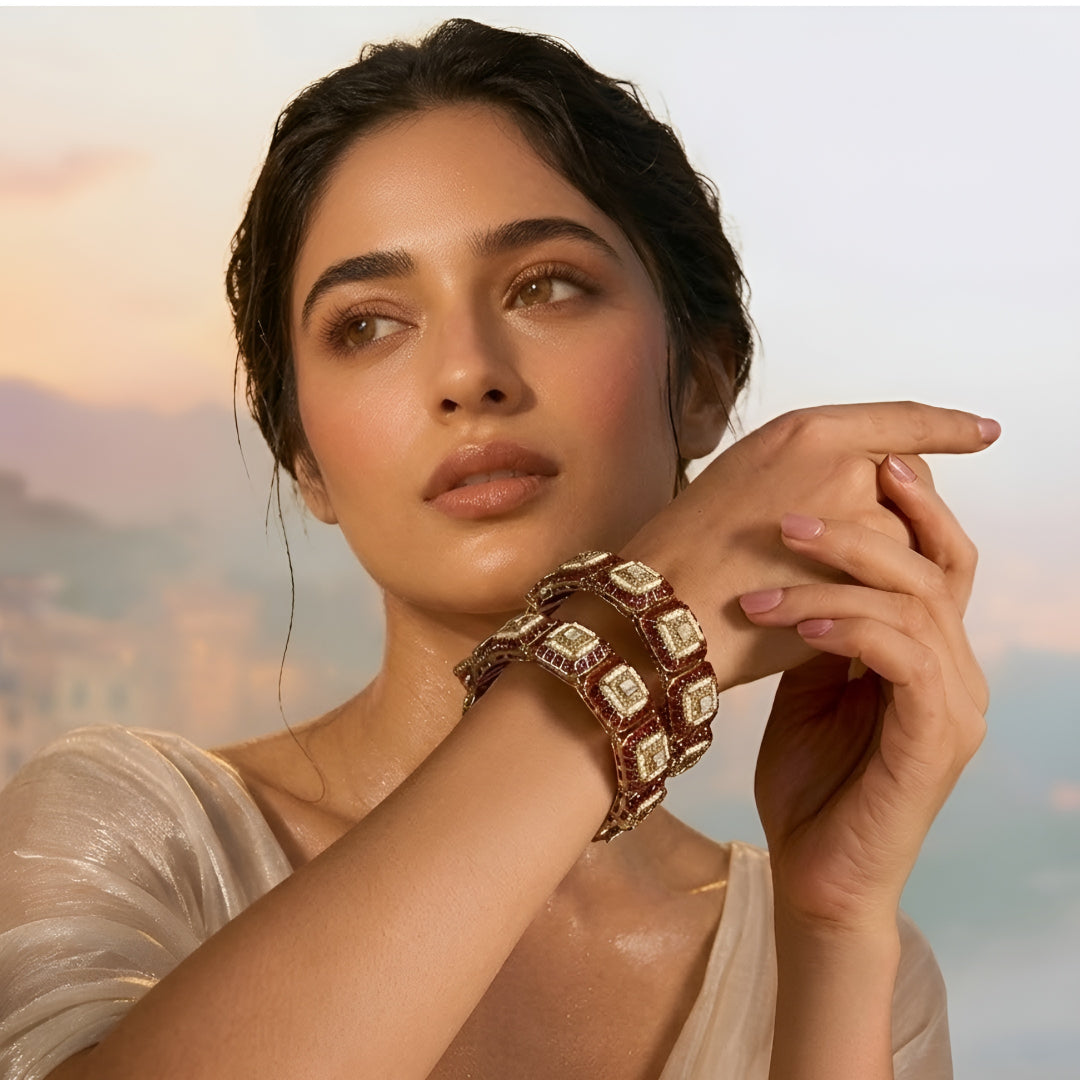Gold-plated designer kada bangles with ruby-red stones and white crystal square motifs for women.