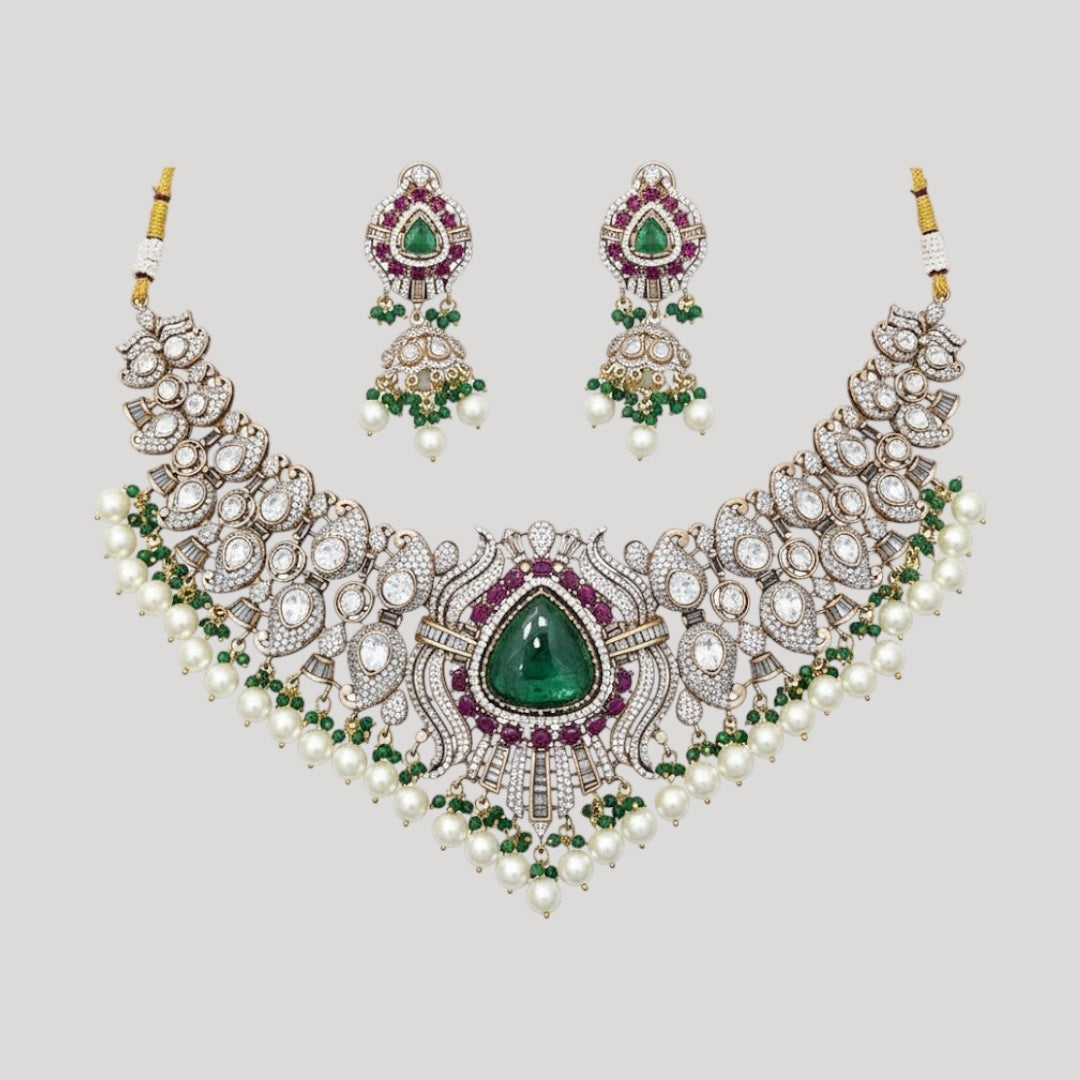 “Bridal Kundan choker necklace set with green center stone, ruby accents, pearls, and matching earrings”