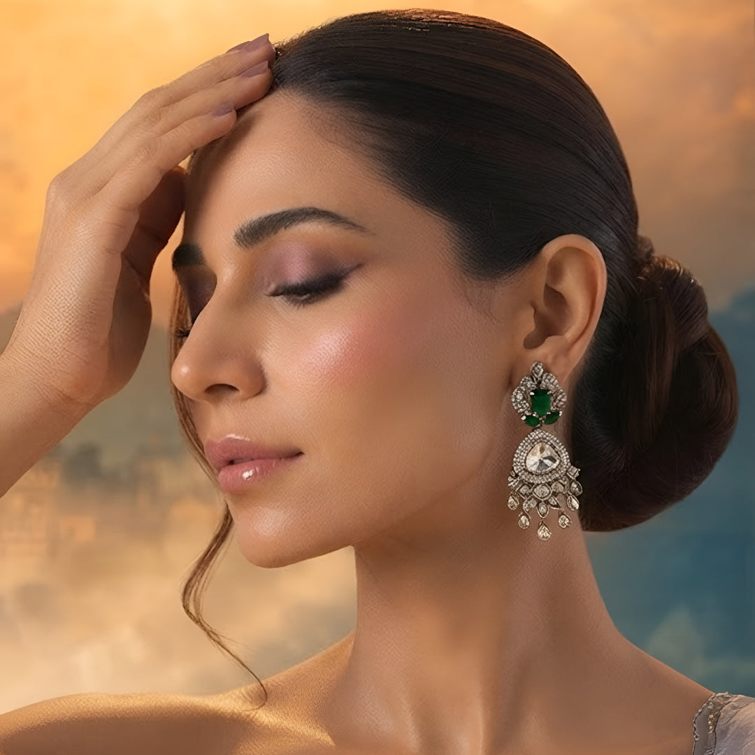 Luxury gold-plated statement earrings with emerald green stones, Kundan stones, sparkling American diamonds, and teardrop danglers for women.