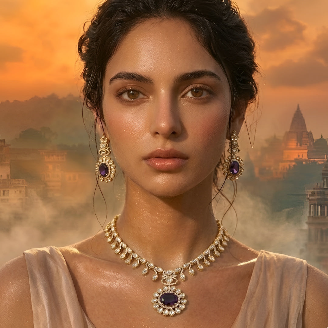 Gold-tone Kundan-inspired necklace and earrings set featuring white stones and deep purple oval gemstone accents in an elegant traditional design.