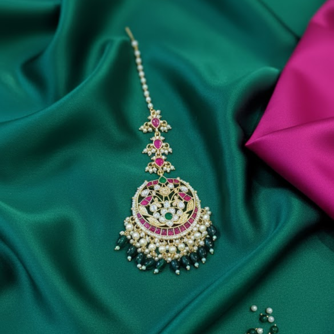 Traditional gold-plated Kundan maang tikka with ruby, emerald, and pearl detailing – bridal headpiece for women