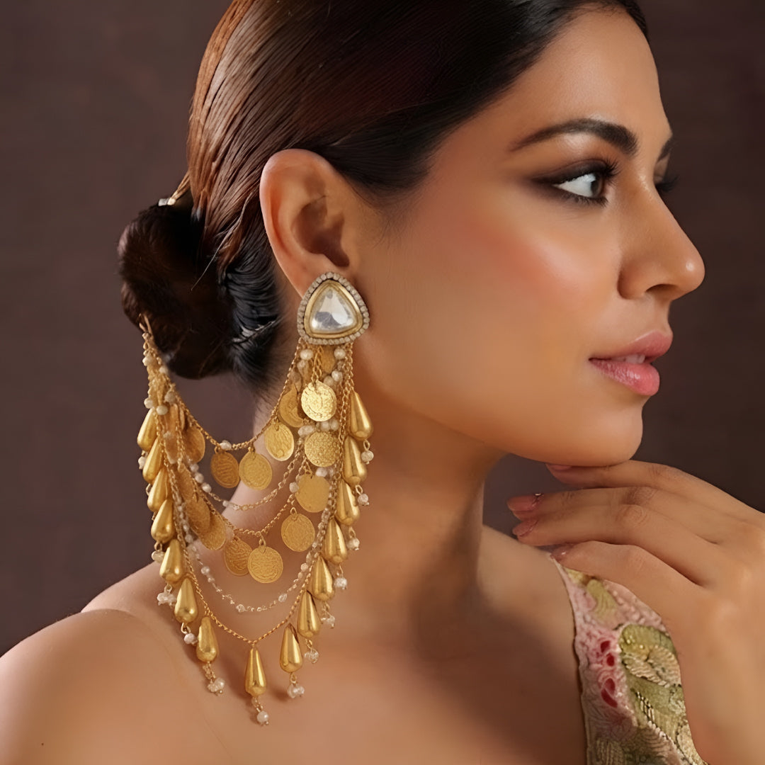 Gold plated Polki ear cuff chain earrings with layered coin charms, tassel drops and pearl accents for bridal and wedding wear.