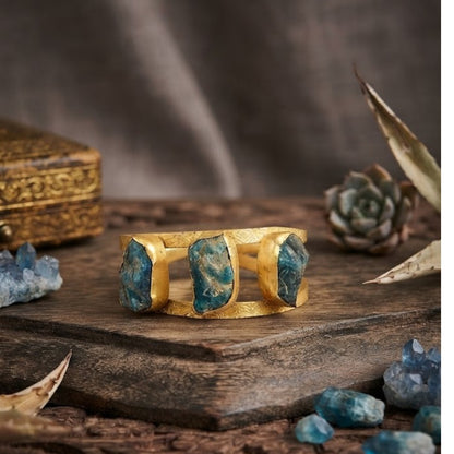 Blue stone gold tone designer cuff bangle with engraved detailing for women