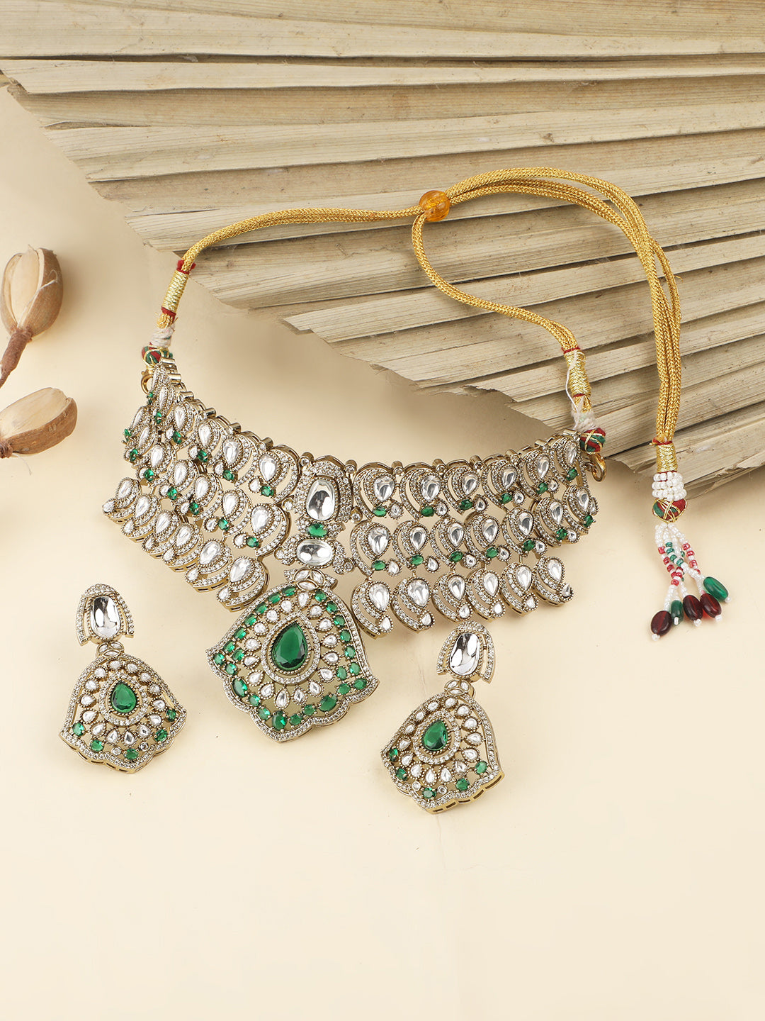 Traditional Kundan choker necklace set with green stones and matching earrings