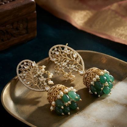 Luxury gold-plated Kundan Polki ear cuff jhumka earrings with green bead drops and pearl detailing for bridal and festive wear.