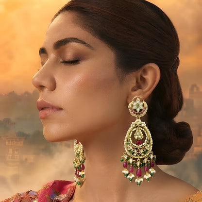Antique gold Kundan Chandbali earrings with ruby and green stones, pearl border, and elegant bead danglers for women.