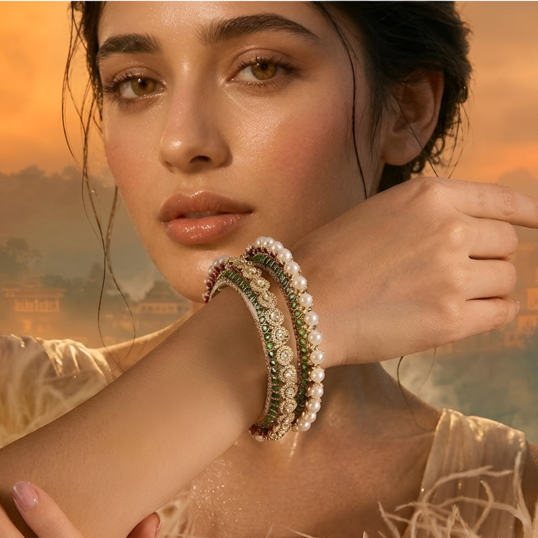 Gold-plated green Kundan bangles with pearl border and sparkling white stones for women.