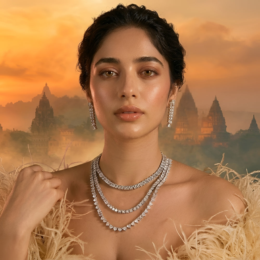 Silver-tone layered crystal necklace with matching drop earrings featuring sparkling clear stones in an elegant bridal jewelry design.