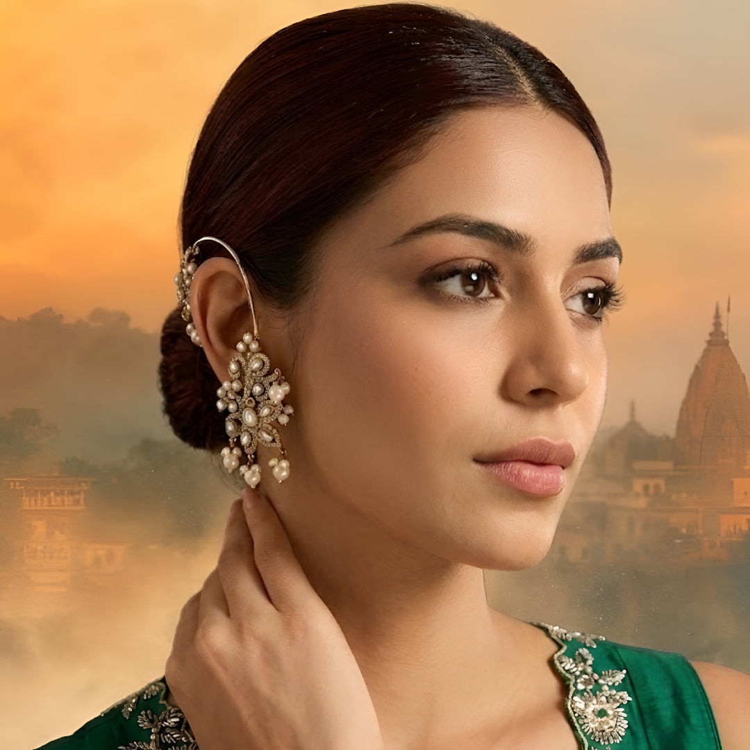Gold-plated crystal and pearl statement earrings with floral design and dangling pearl accents for weddings and party wear.