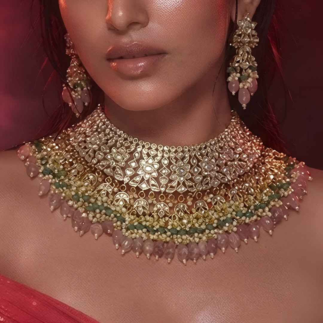"Antique gold bib-style kundan necklace with matching floral earrings"