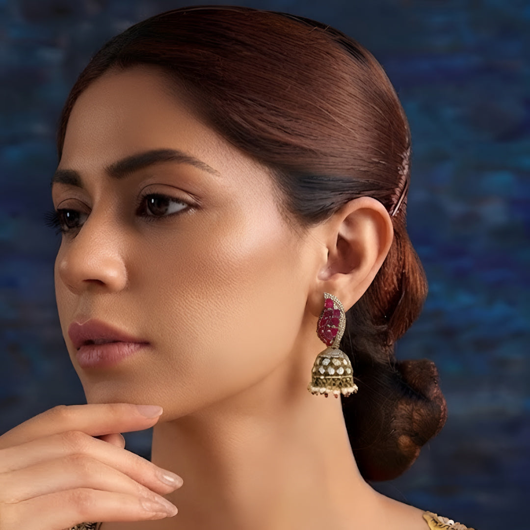 Antique gold Kundan jhumka earrings with ruby stones, sparkling American diamonds, and pearl drop fringe for women.