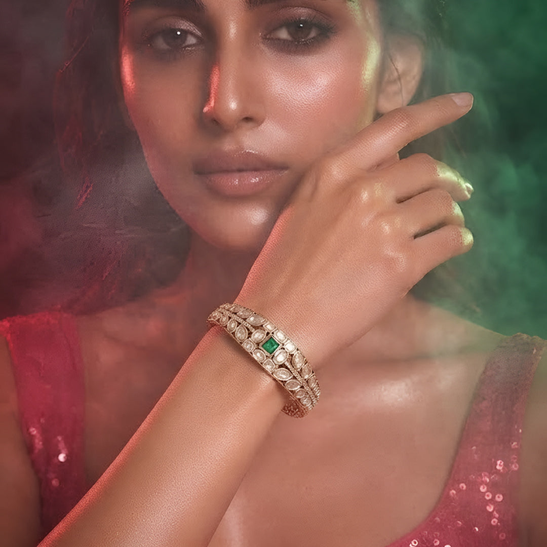 Green stone AD studded gold tone designer kada bracelet with intricate leaf detailing