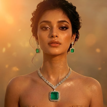 Elegant emerald green crystal pendant necklace set with sparkling zircon-studded chain and matching drop earrings in a gold-tone finish.