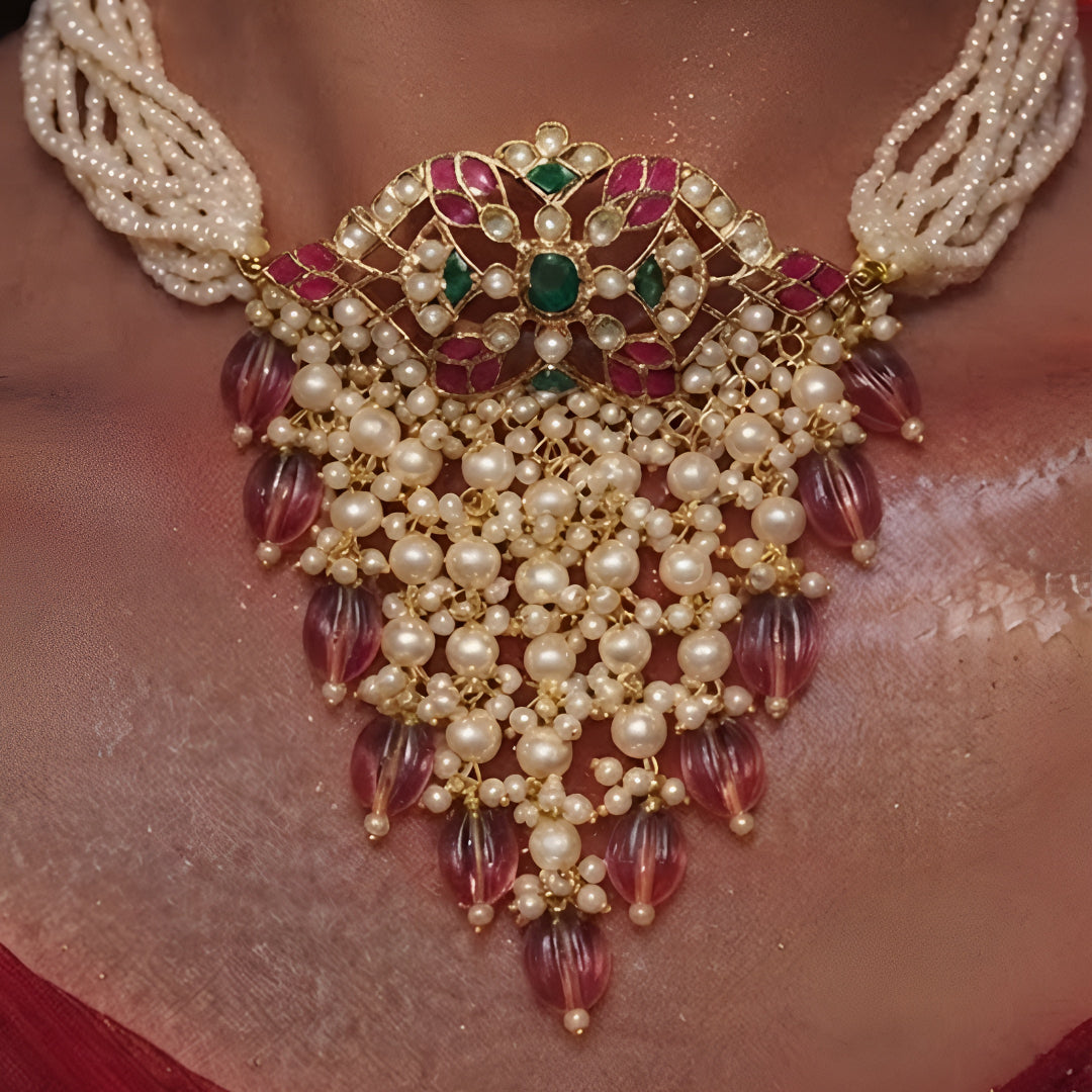 "Traditional Indian bridal jewelry set with pearl strands and maroon beaded tassels"