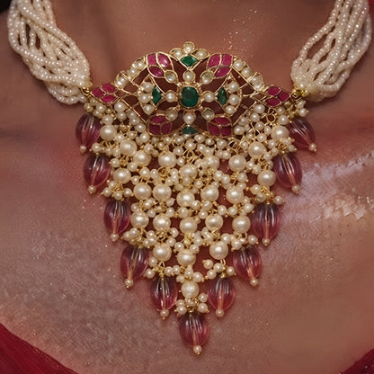 "Traditional Indian bridal jewelry set with pearl strands and maroon beaded tassels"