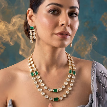 Gold-plated double-layer Kundan necklace set featuring emerald green rectangular stones, Polki-style hexagonal stones, and matching drop earrings for women.