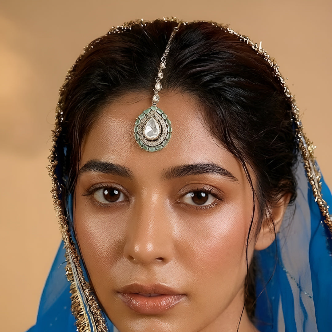 Gold-plated mint green Kundan maang tikka with teardrop American Diamond pendant for bridal, wedding, festive, and ethnic wear.