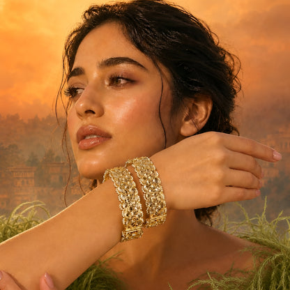 Gold-plated Kundan bangles with teardrop stones and pearl bead detailing for women, ideal for bridal and festive wear.