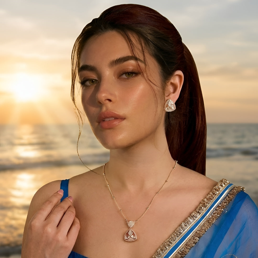 Gold-plated pink stone pendant necklace set with matching stud earrings featuring marquise-cut crystals and elegant enamel detailing.