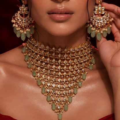 "Woman wearing gold Kundan choker necklace set with green beaded drops and matching chandbali earrings, bridal jewellery"