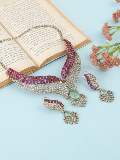 Gold plated ruby and emerald statement necklace set with matching earrings, bridal jewelry design with teardrop green stone and crystal detailing