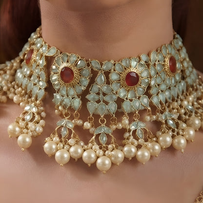 Traditional gold-plated Kundan pearl choker necklace set with ruby-red stones and matching stud earrings for women.