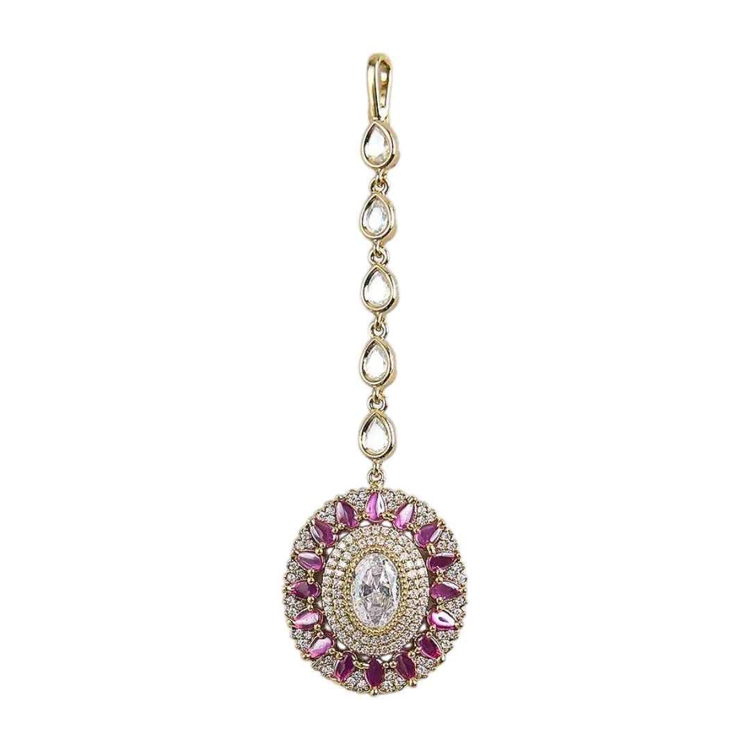 "Gold-plated pink American diamond bridal maang tikka with oval crystal centerpiece and marquise stones for women on white background."