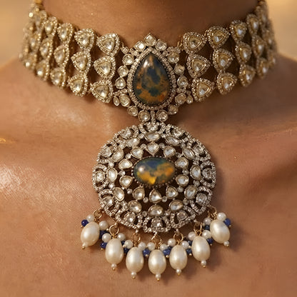 Royal blue stone Kundan choker necklace set with matching statement earrings featuring white Kundan stones, blue center stones, and pearl drop detailing.