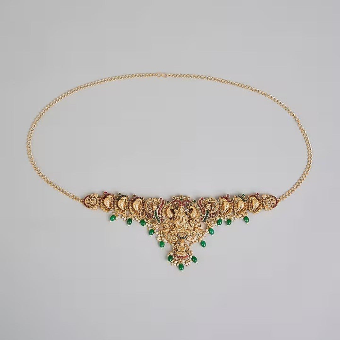 Traditional gold plated Lakshmi temple waist belt (Vaddanam) with green bead drops and pearl accents for bridal, wedding, festive, and classical dance wear.