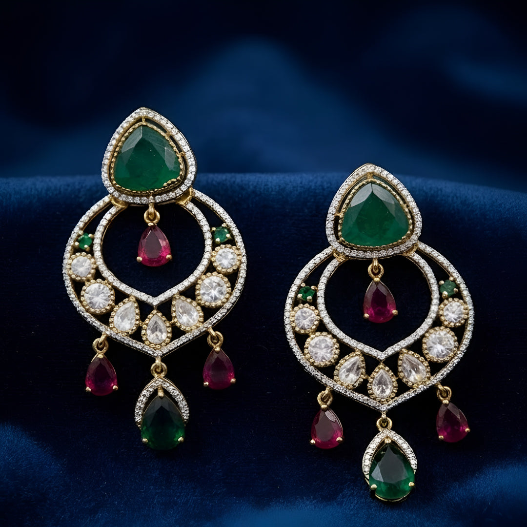 Luxury gold-plated statement earrings with emerald green teardrop stones, ruby drop accents, and sparkling American diamonds for women.