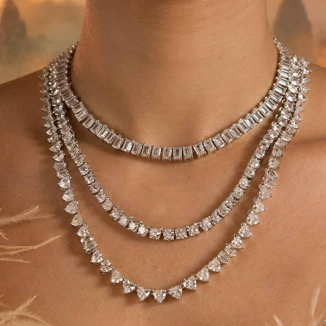 Silver-tone layered crystal necklace with matching drop earrings featuring sparkling clear stones in an elegant bridal jewelry design.