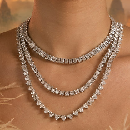 Silver-tone layered crystal necklace with matching drop earrings featuring sparkling clear stones in an elegant bridal jewelry design.