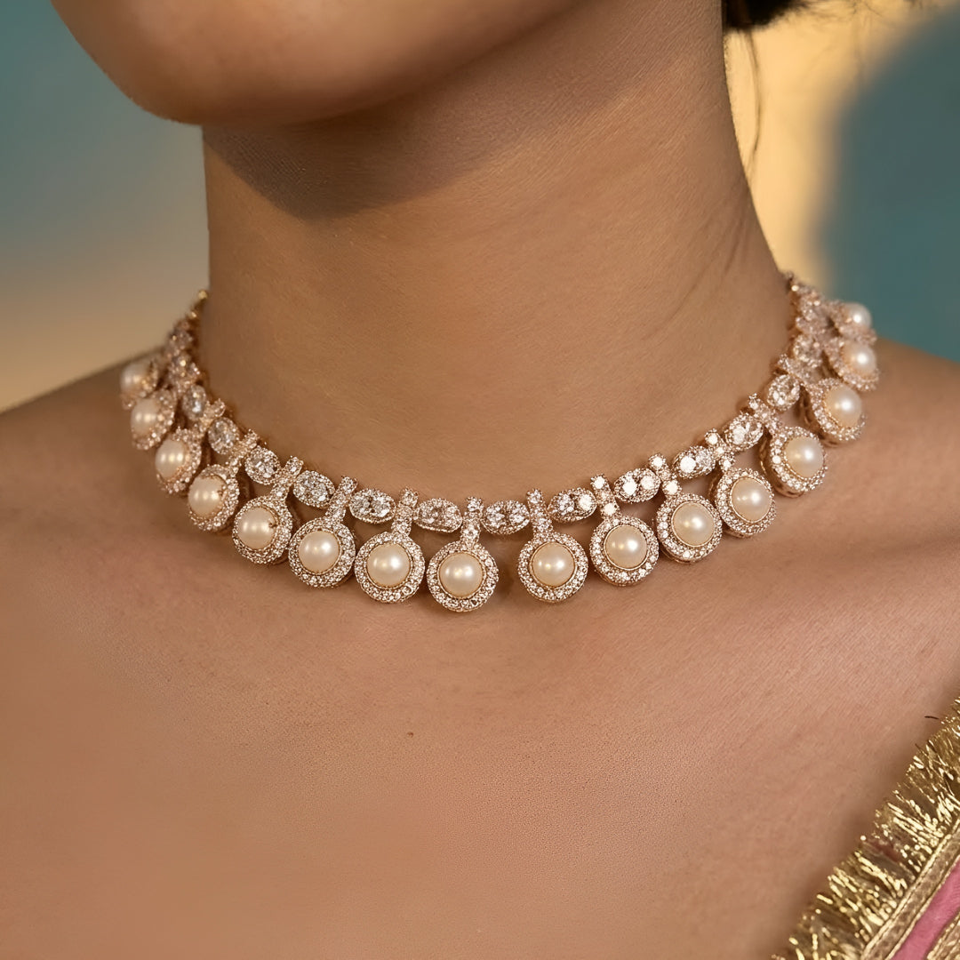 Gold-tone statement necklace set with ivory cabochon stones, crystal embellishments, and matching earrings on white background.