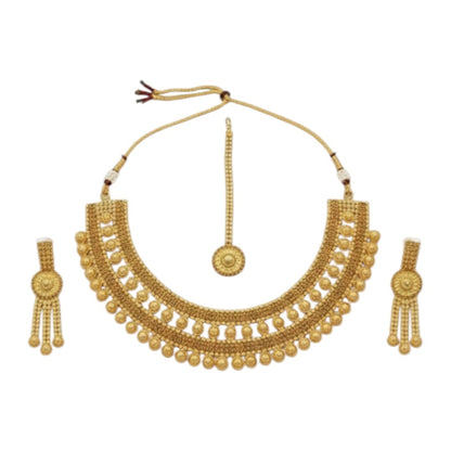 Traditional bridal gold-plated Kundan necklace set with matching earrings and maang tikka displayed on red velvet stand.