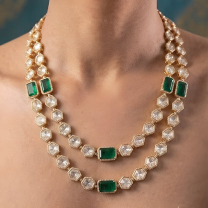 Gold-plated double-layer Kundan necklace set featuring emerald green rectangular stones, Polki-style hexagonal stones, and matching drop earrings for women.