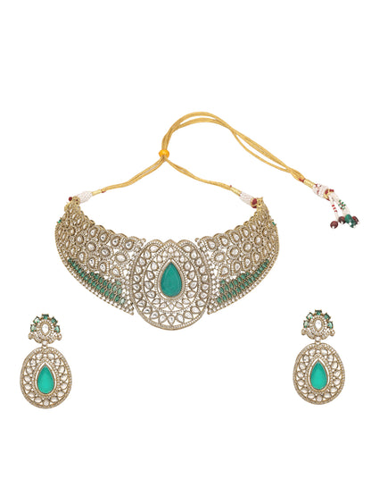 Gold-tone choker necklace set with intricate kundan-style detailing, highlighted by a large teardrop green stone centerpiece and matching drop earrings.