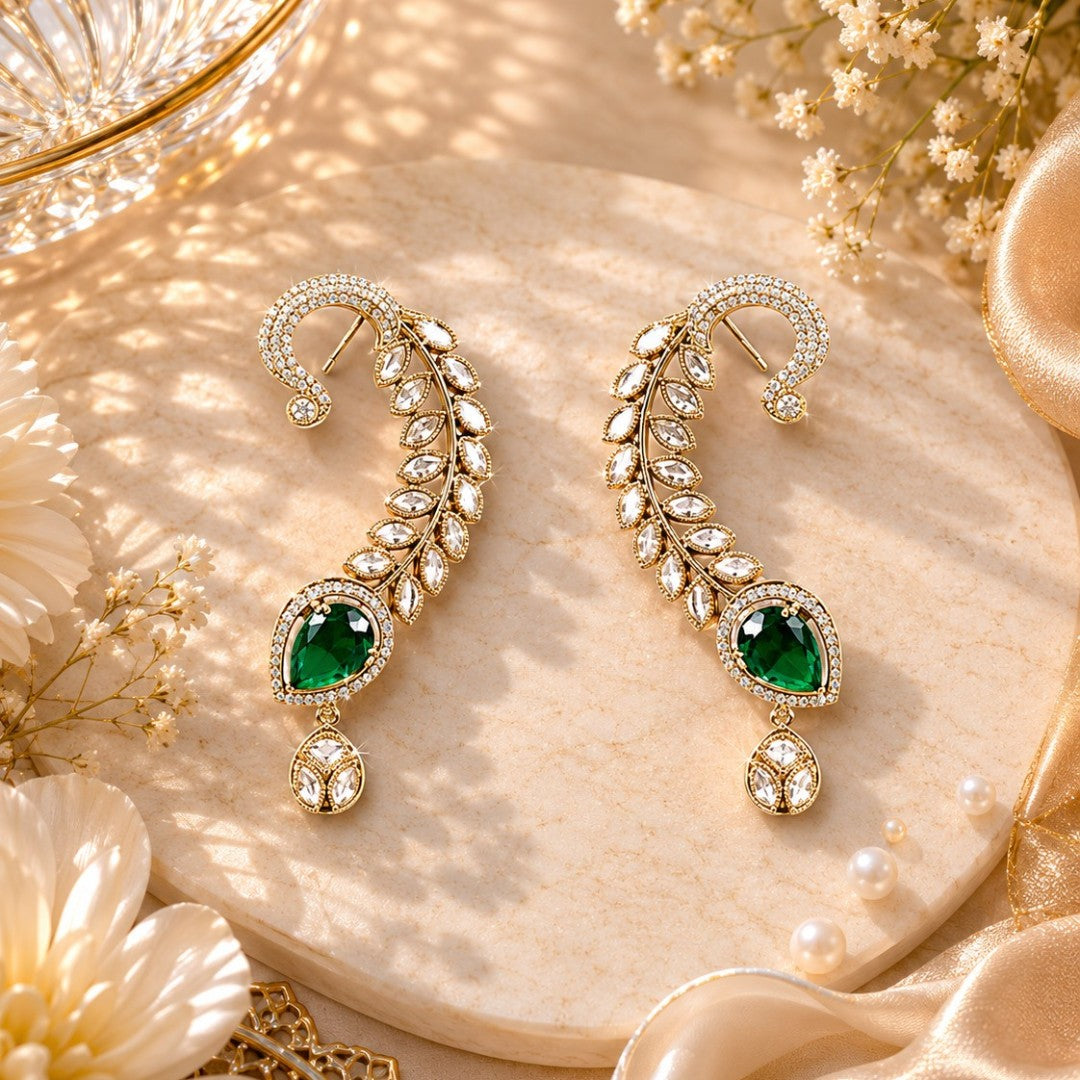 Gold-plated leaf design ear cuff earrings with emerald green teardrop stones and sparkling crystal embellishments for women.