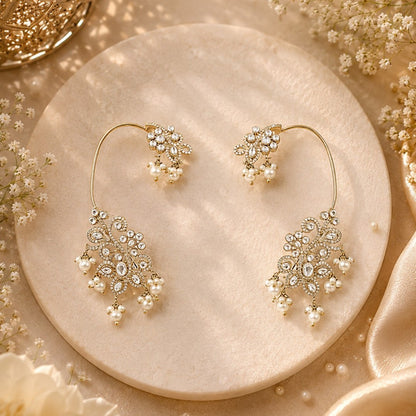 Gold-plated crystal and pearl statement earrings with floral design and dangling pearl accents for weddings and party wear.