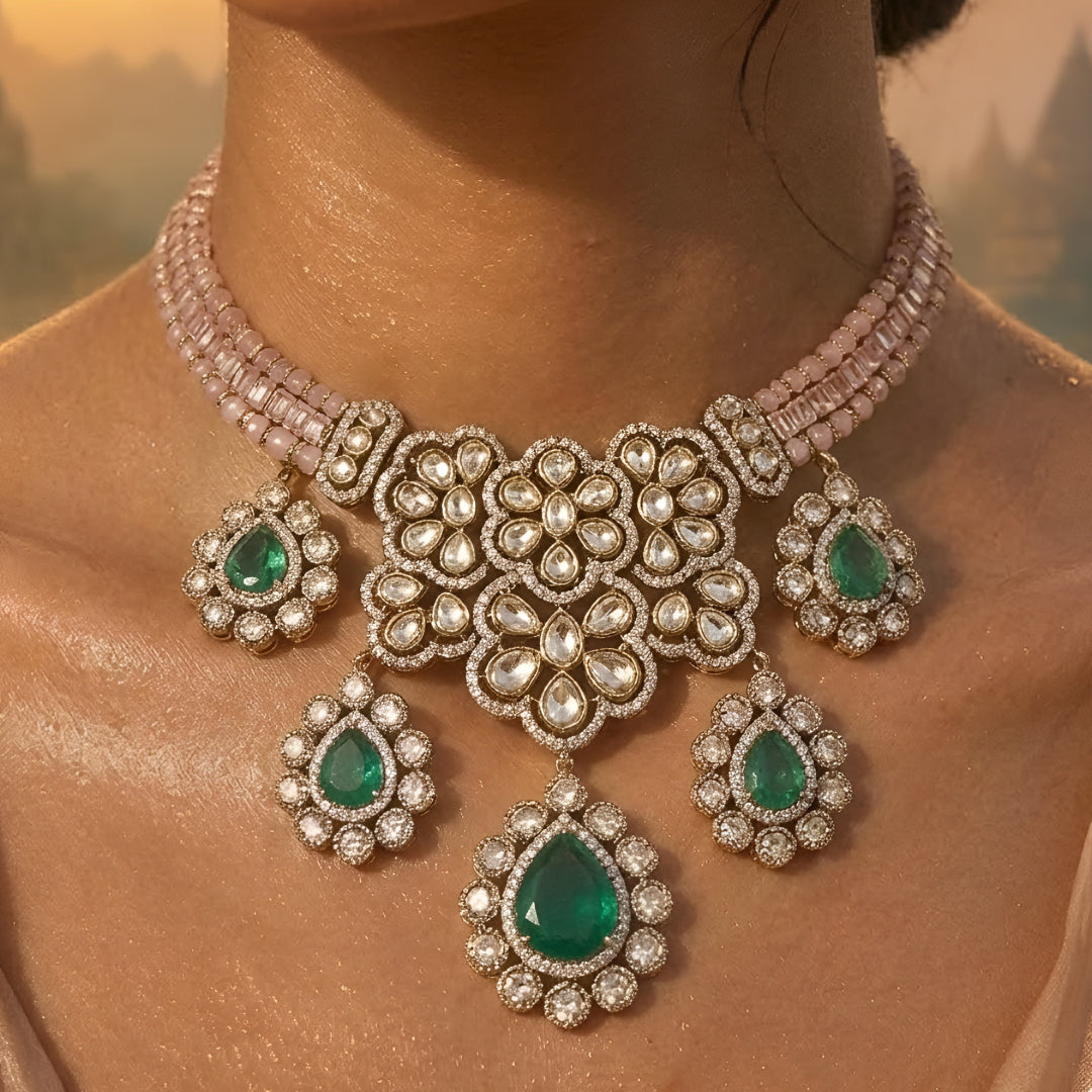 Traditional emerald green kundan choker necklace set with floral motifs and matching drop earrings for bridal and festive wear.