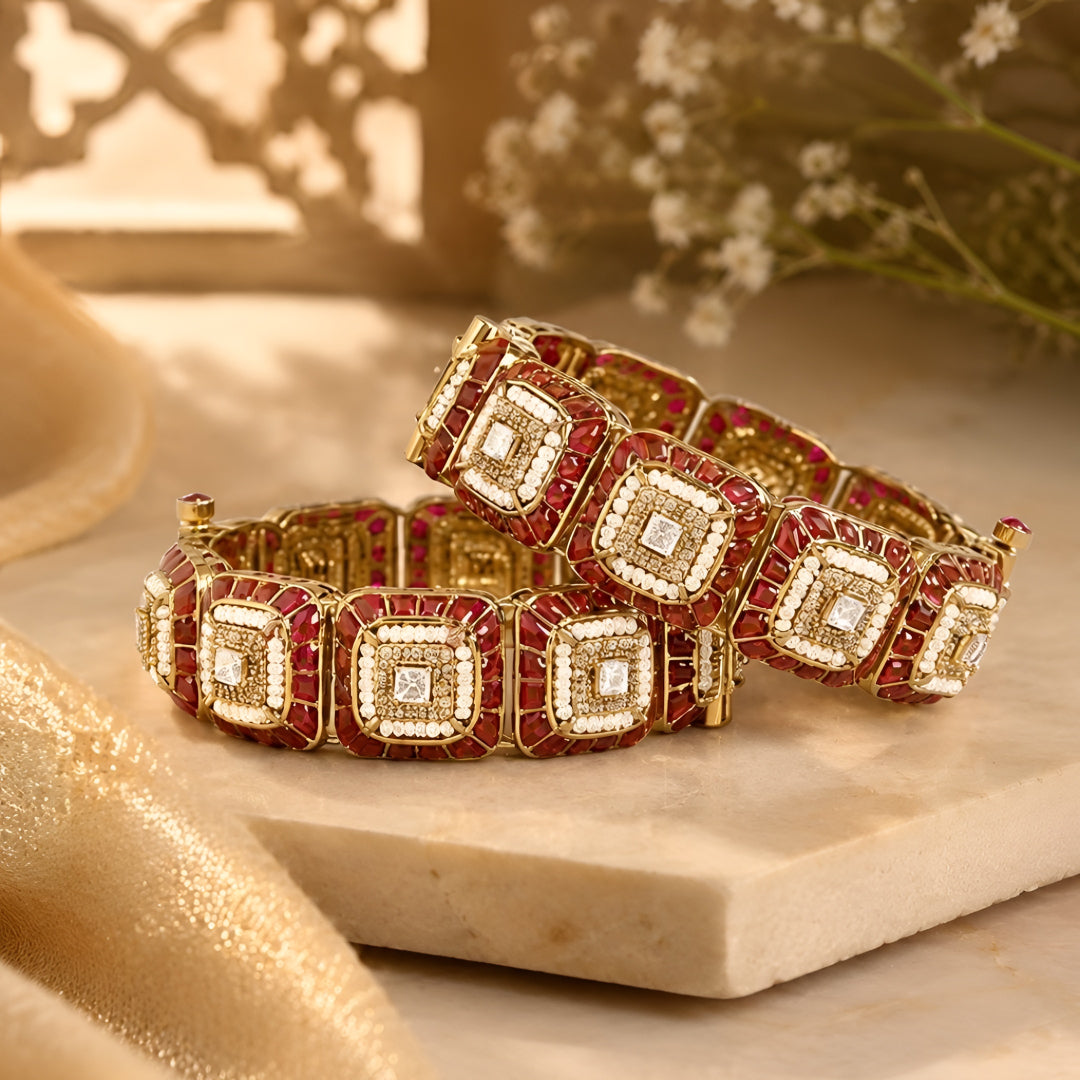 Gold-plated designer kada bangles with ruby-red stones and white crystal square motifs for women.