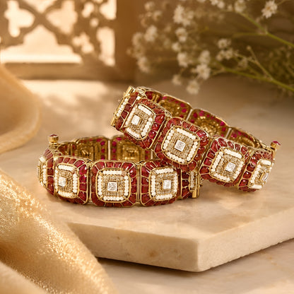 Gold-plated designer kada bangles with ruby-red stones and white crystal square motifs for women.