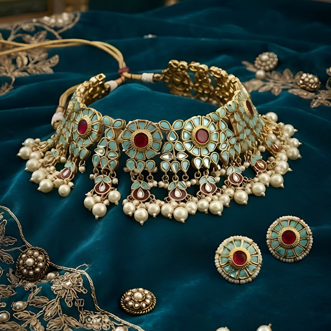 Traditional gold-plated Kundan pearl choker necklace set with ruby-red stones and matching stud earrings for women.