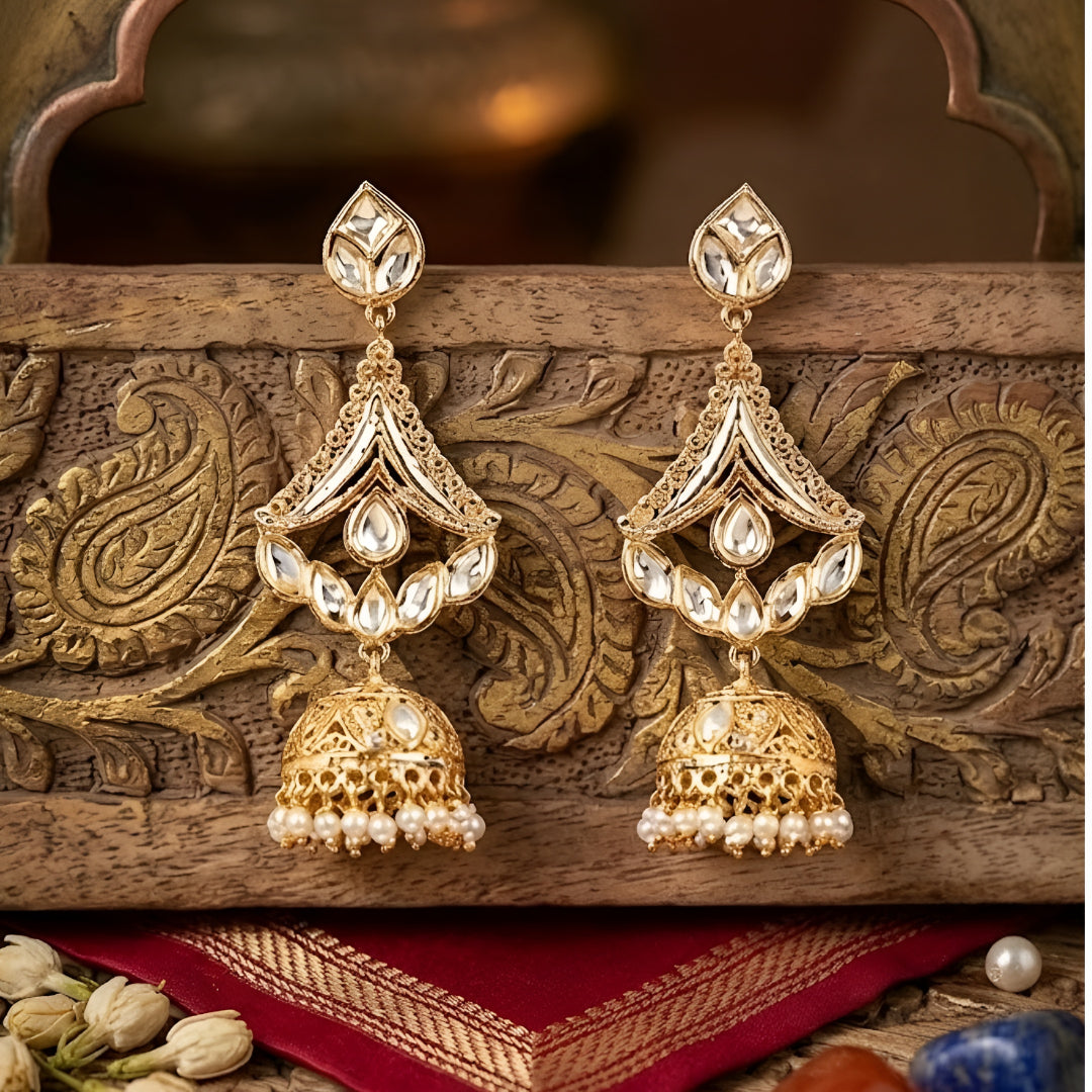 Gold-plated Kundan jhumka earrings with teardrop stones and pearl drops for women