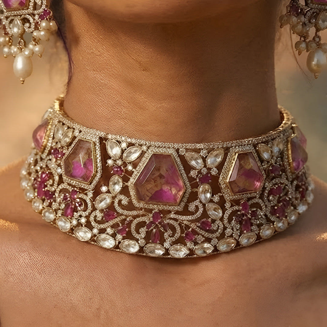 Royal pink Kundan bridal choker necklace set with matching earrings featuring white Kundan stones, floral detailing, pink statement stones, and pearl drop accents.